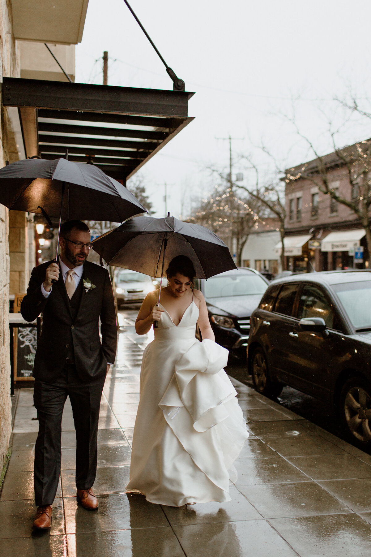 A moody candid of a couple on their rainy wedding day captured by Fort Worth Wedding Photographer, Megan Christine Studio