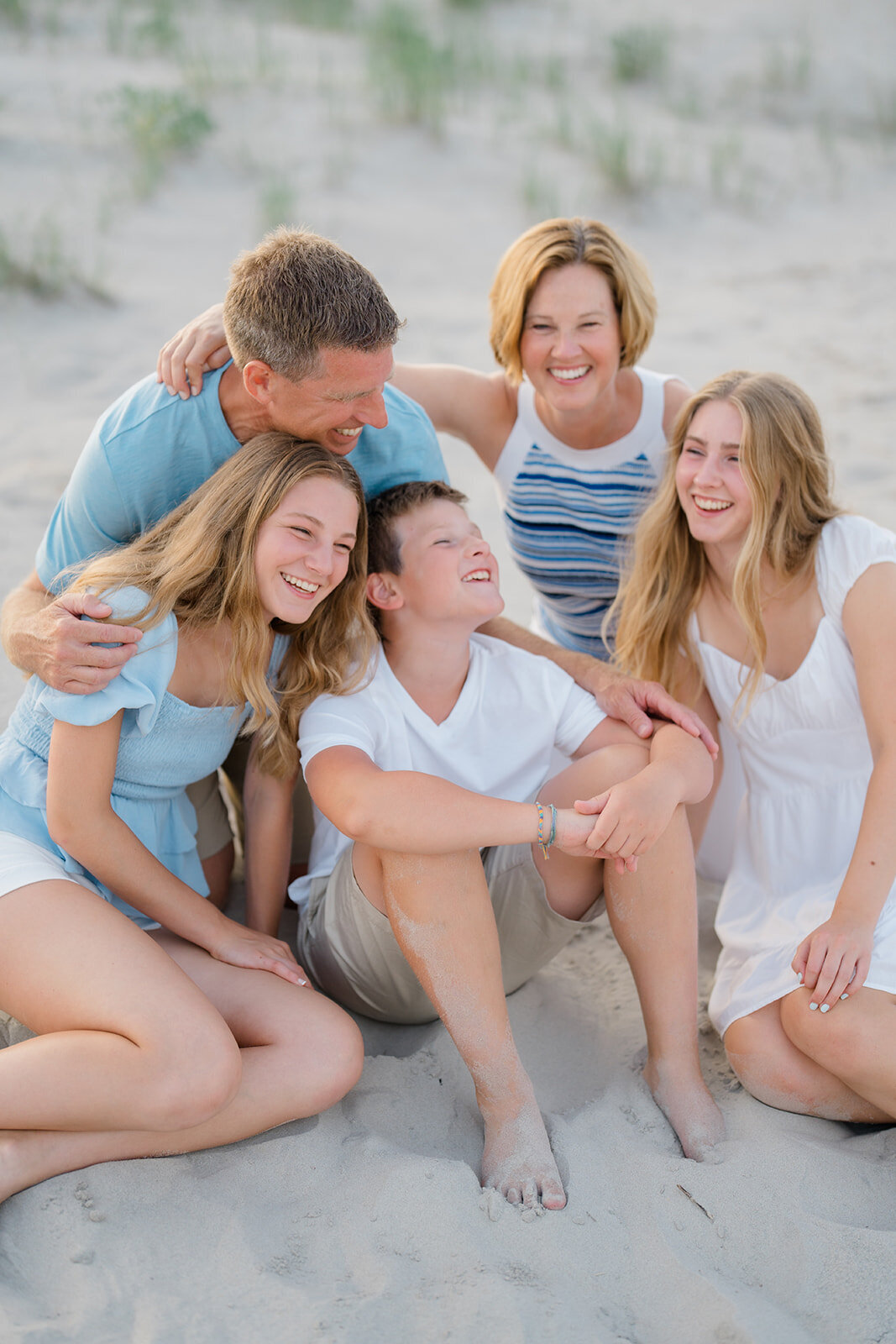 Family laughing together on the beach in Stone Harbor, NJ