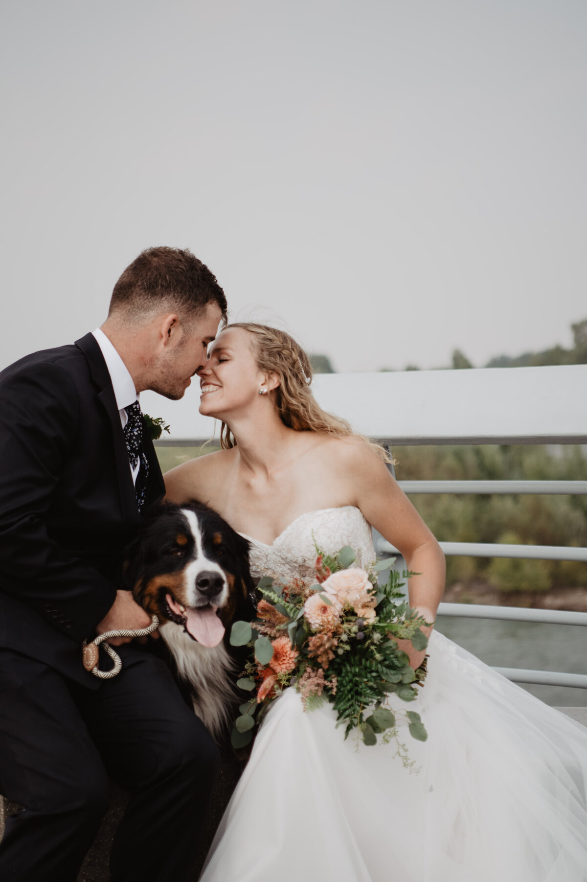 Jackson Hole Photographers capture couple kissing with dog