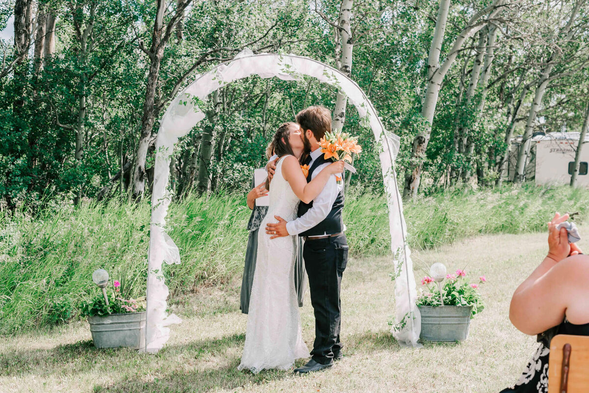 Bride and groom share their first kiss as husband and wide.