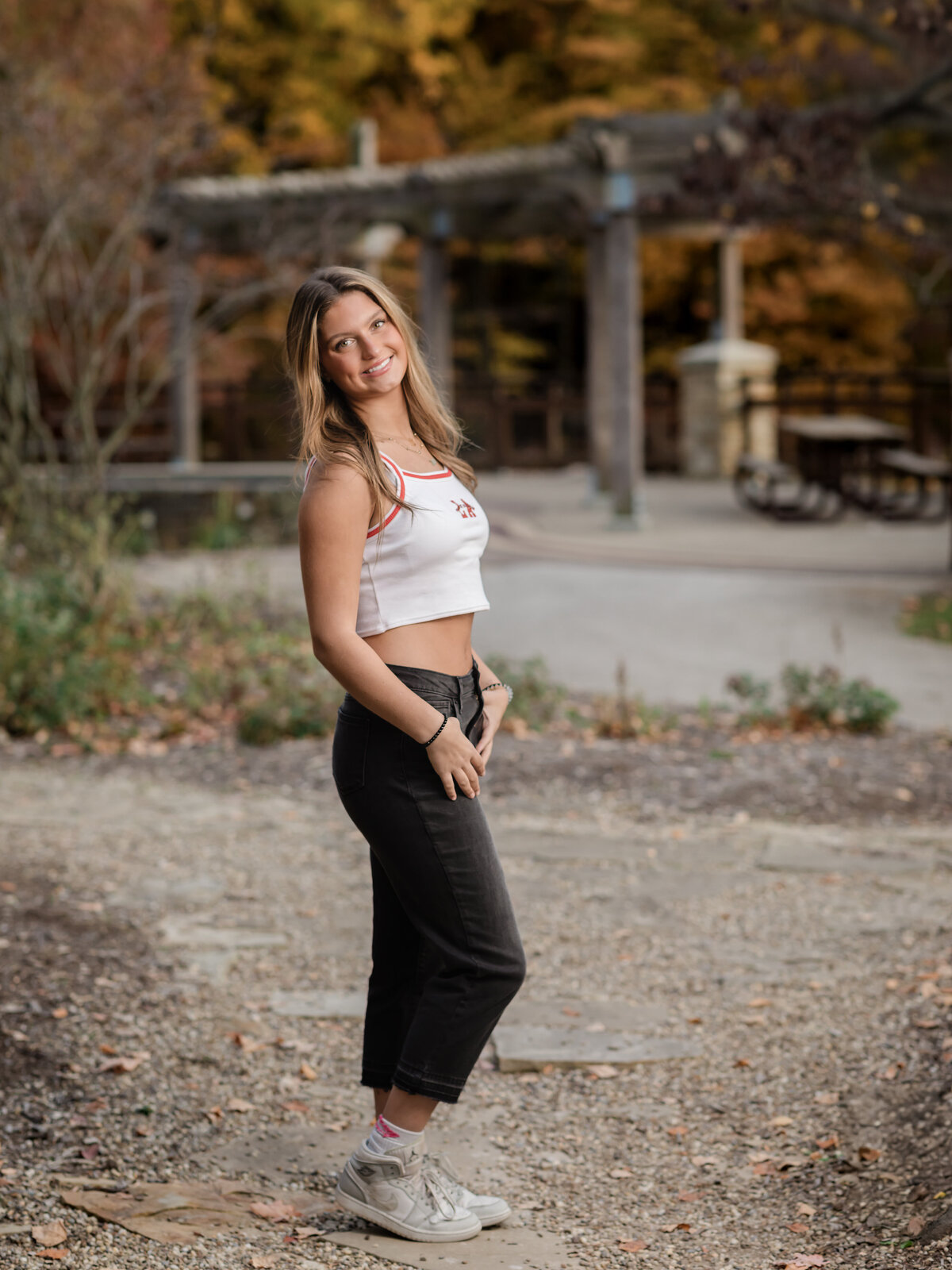 senior girl in white top posing for senior photos at Westcreek Reservation in Parma, Ohio cleveland senior photographer
