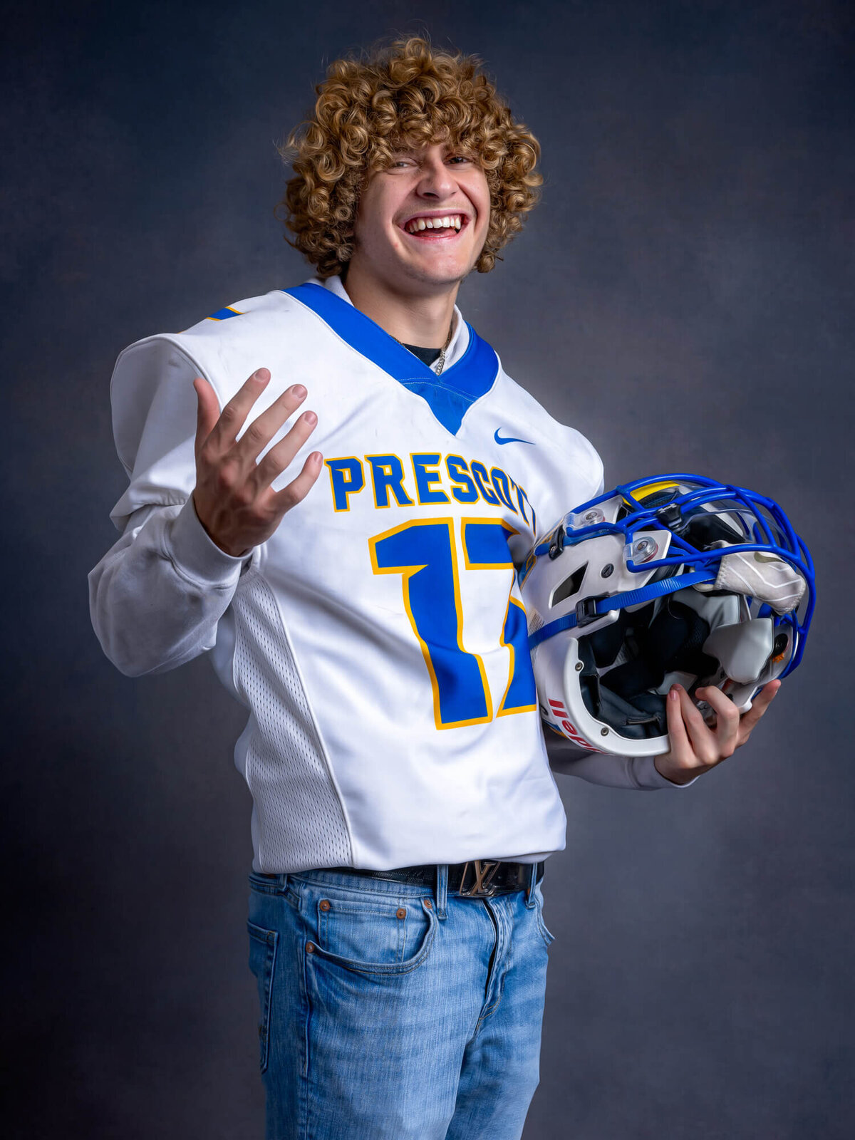 Football player poses in Prescott senior photos