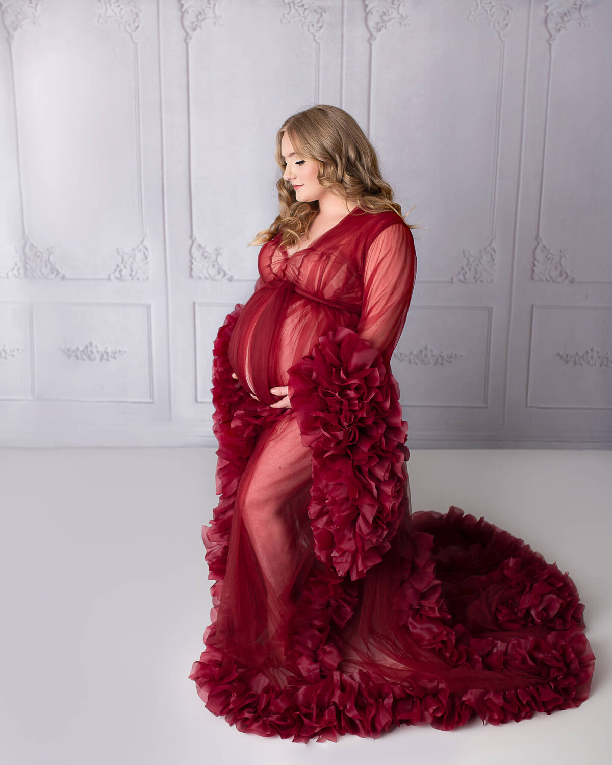 Fine art in studio maternity cleveland  with mom in sheer red dress.