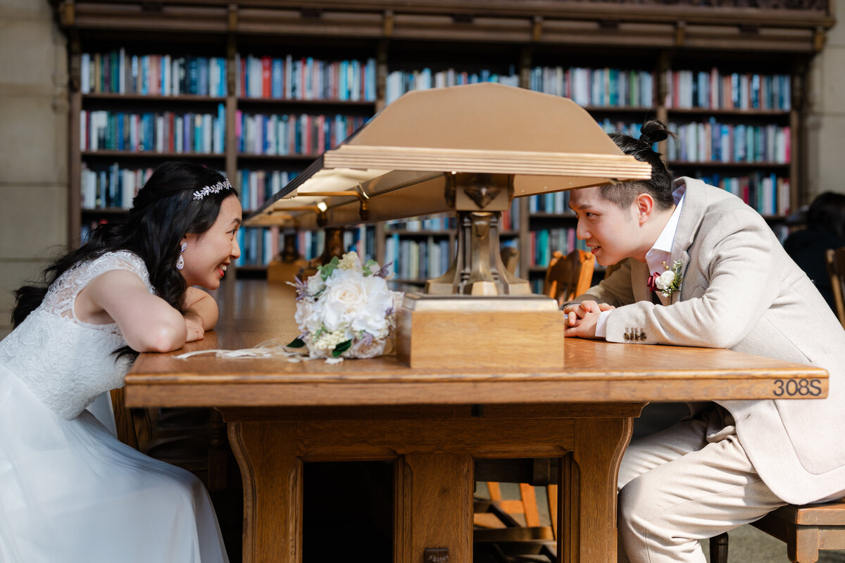 wedding couple in library at table