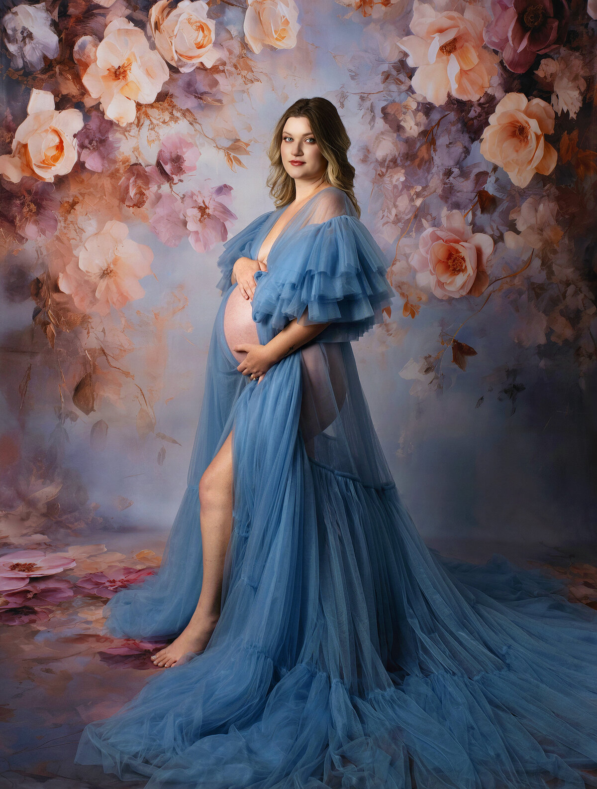 Fine art maternity portrait in Seattle — elegant expectant mother in flowing gown with painterly backdrop and artistic lighting. 