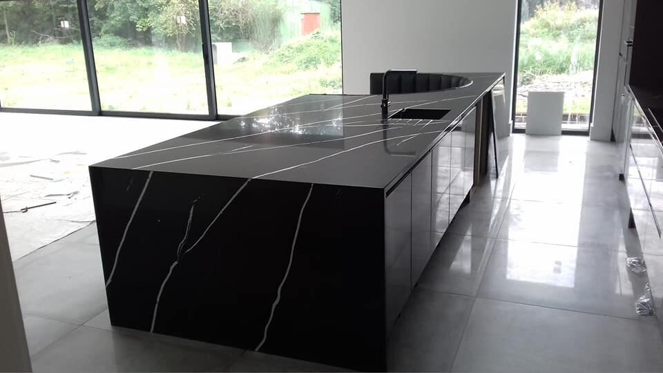 Black and white countertops in black kitchen