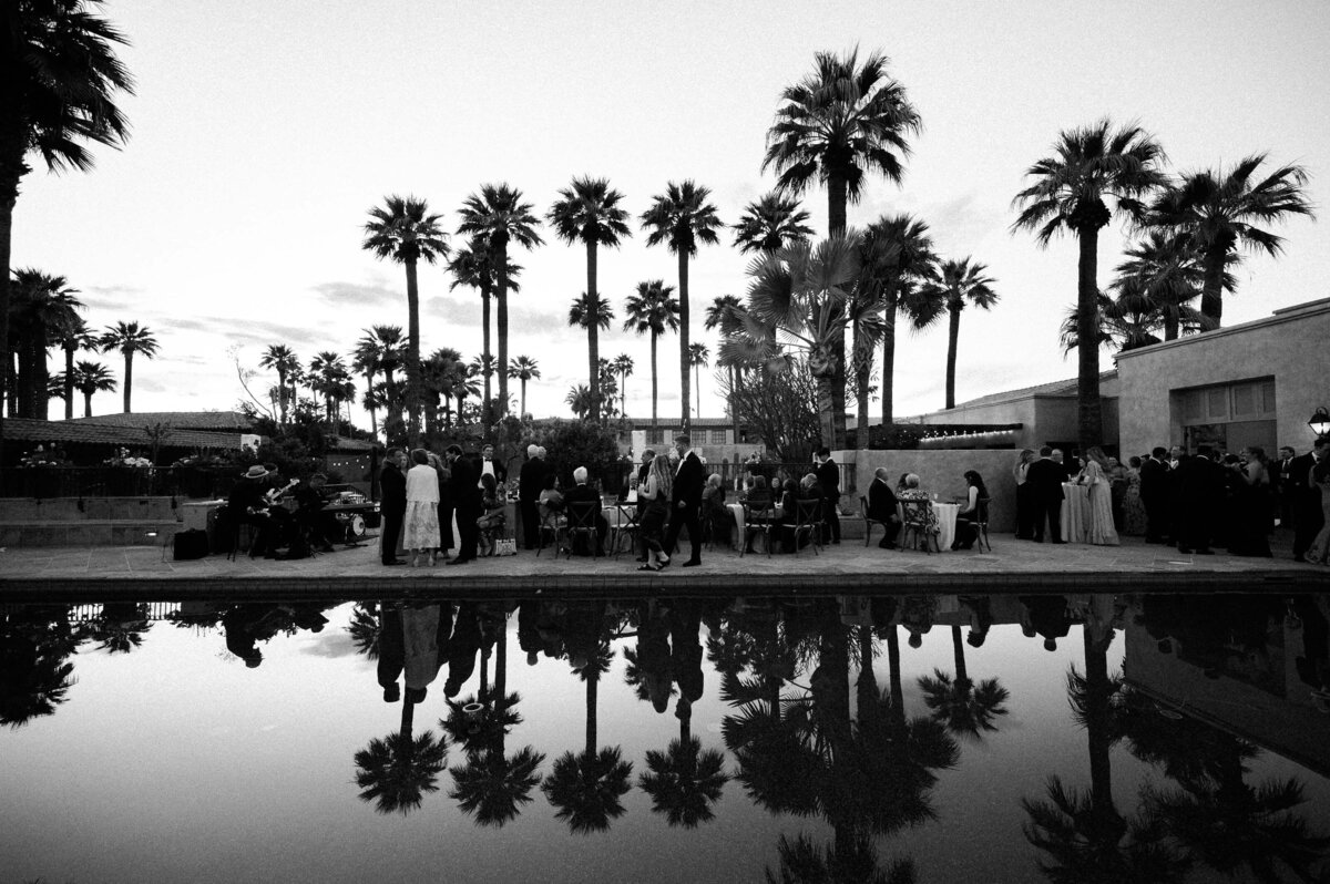 Evening cocktail hour by the reflecting pool at Royal Palms Resort in Phoenix, captured by Arizona wedding photographers.