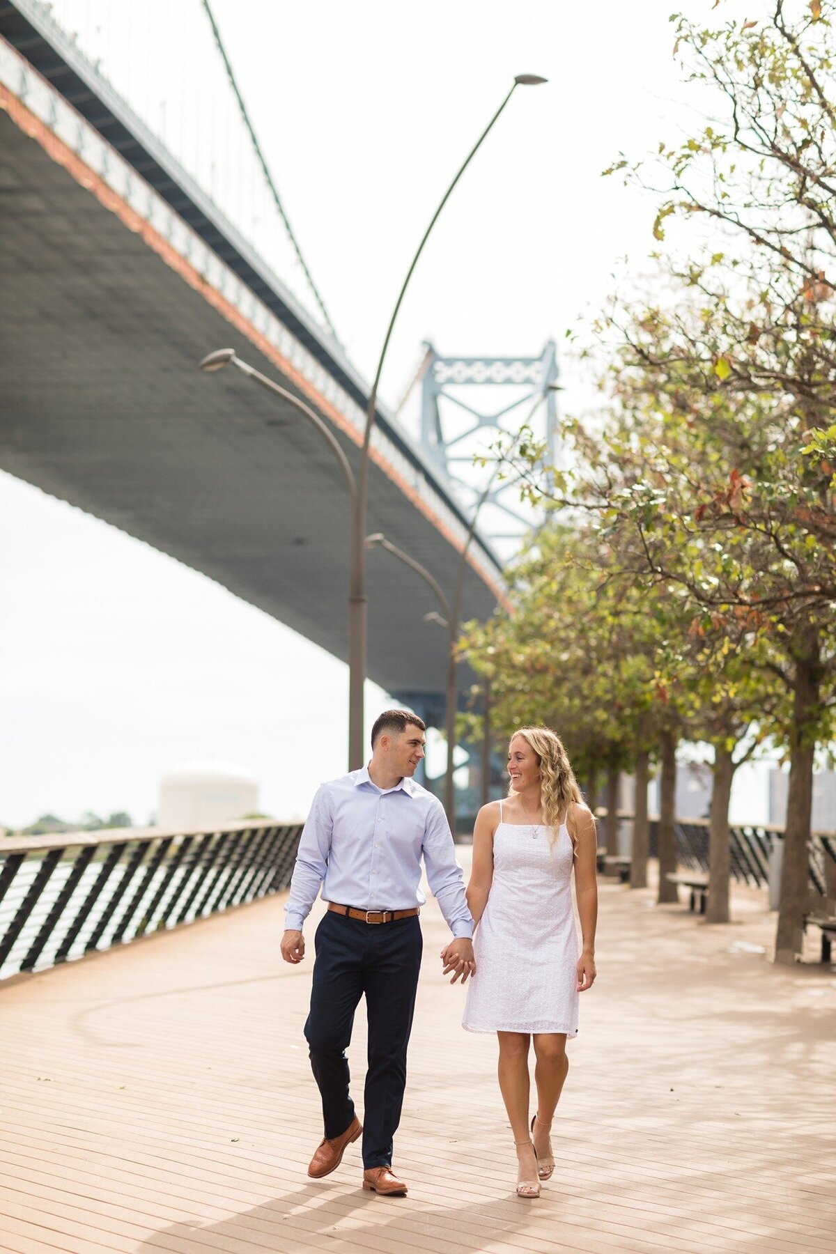 engaged-couple-walking-race-street-pier