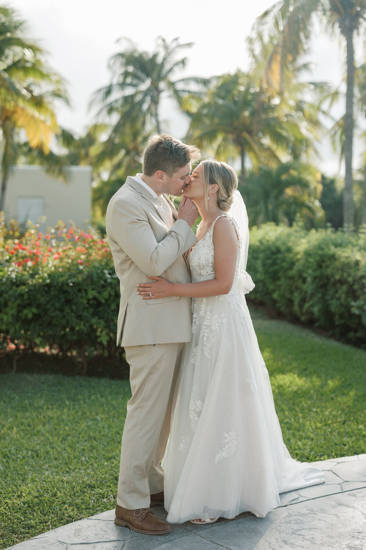 Groom kisses bride during sunset in Cancun, Mexico, captured by a Philadelphia wedding photographer.