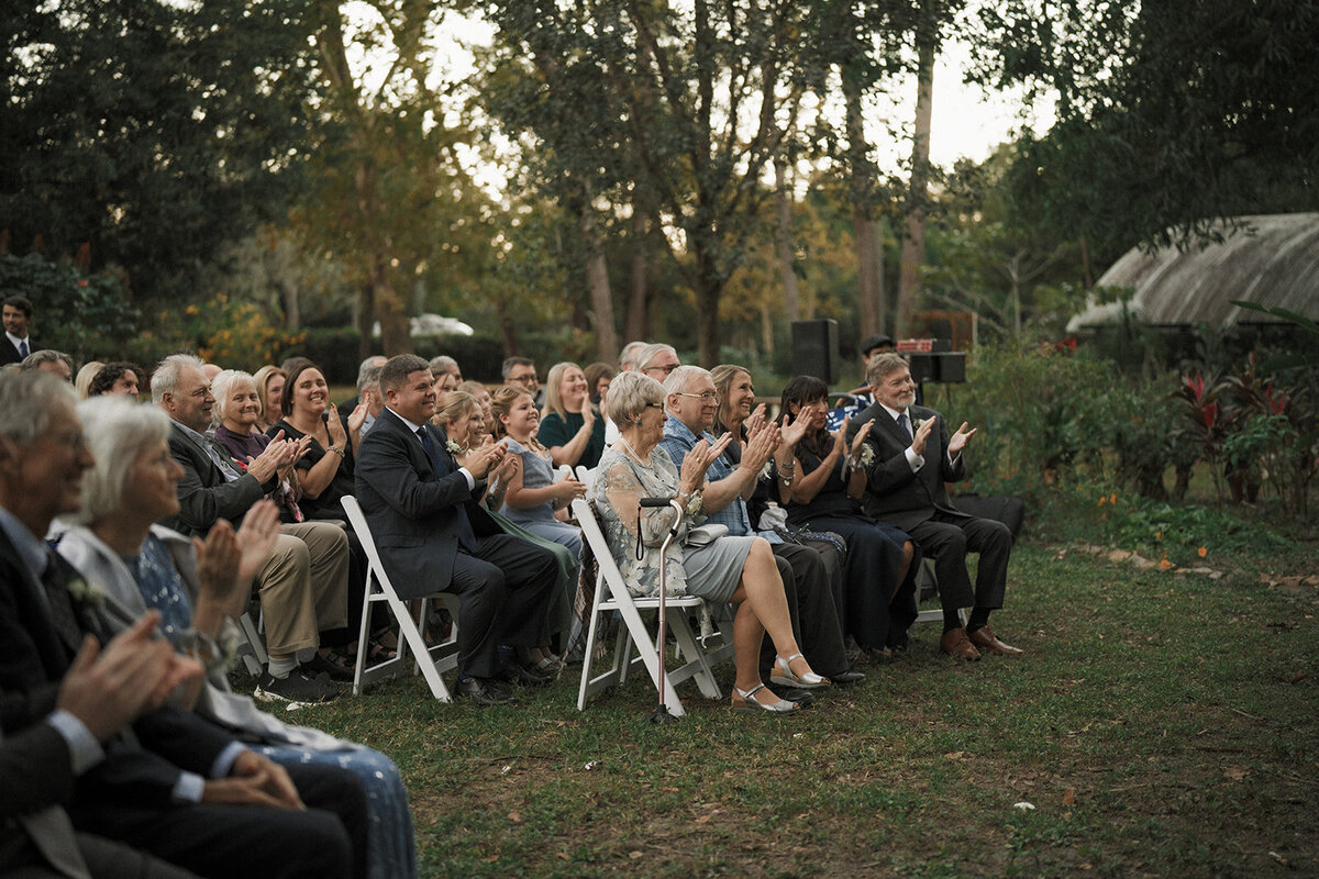 wedding guests outdoors clapping