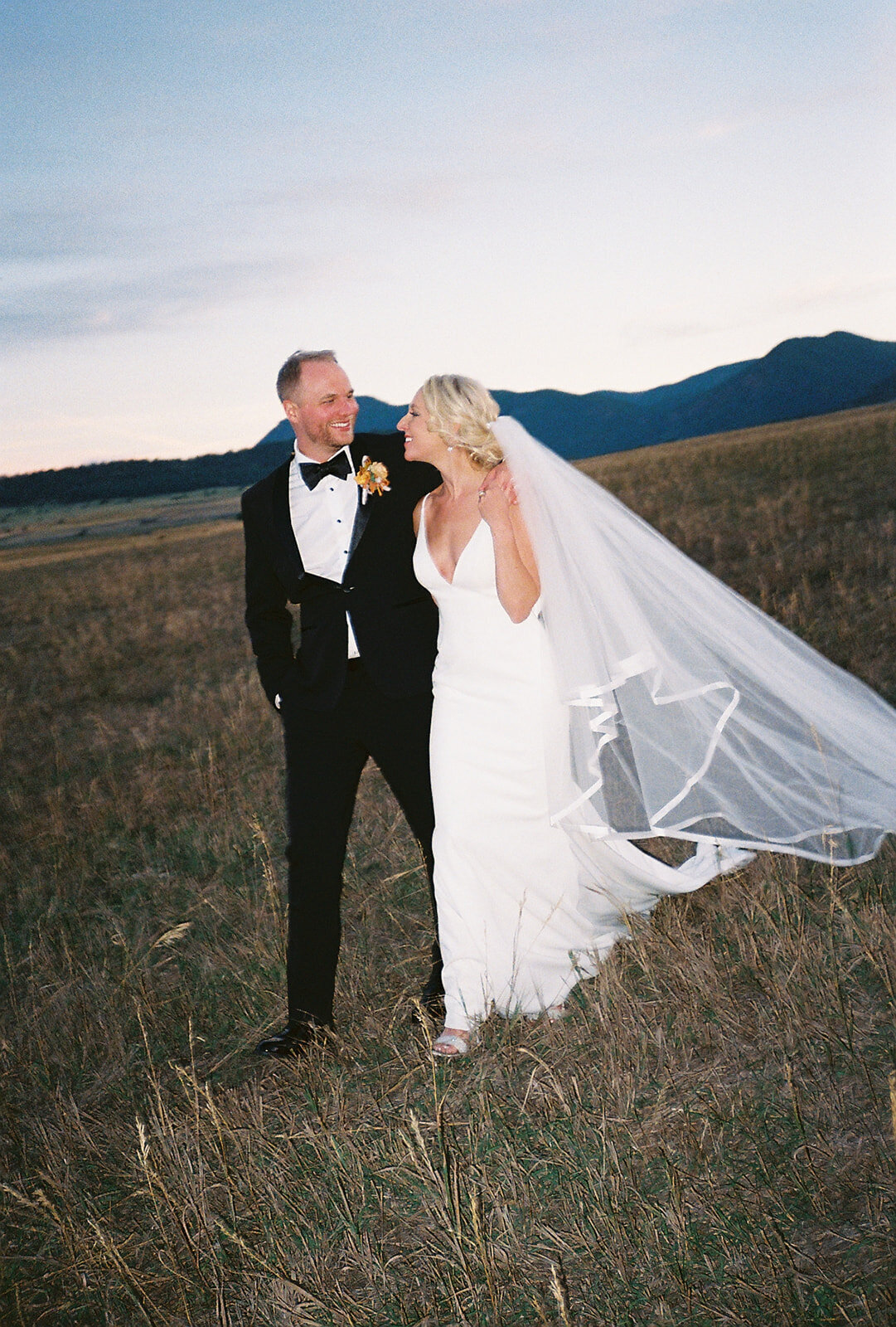 Candid wedding portrait of a couple in downtown Denver, taken by a documentary wedding photographer.