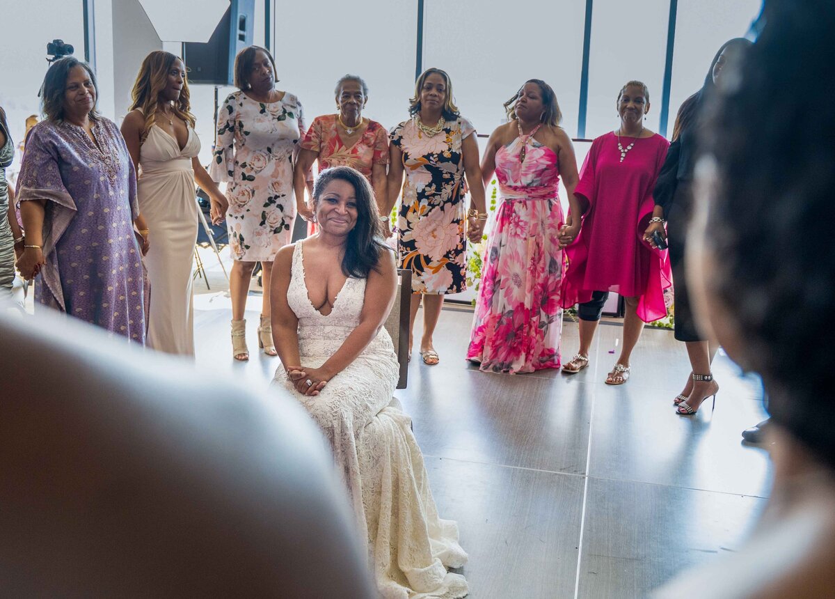 Bride is surrounded by sorority sisters during wedding recepption.