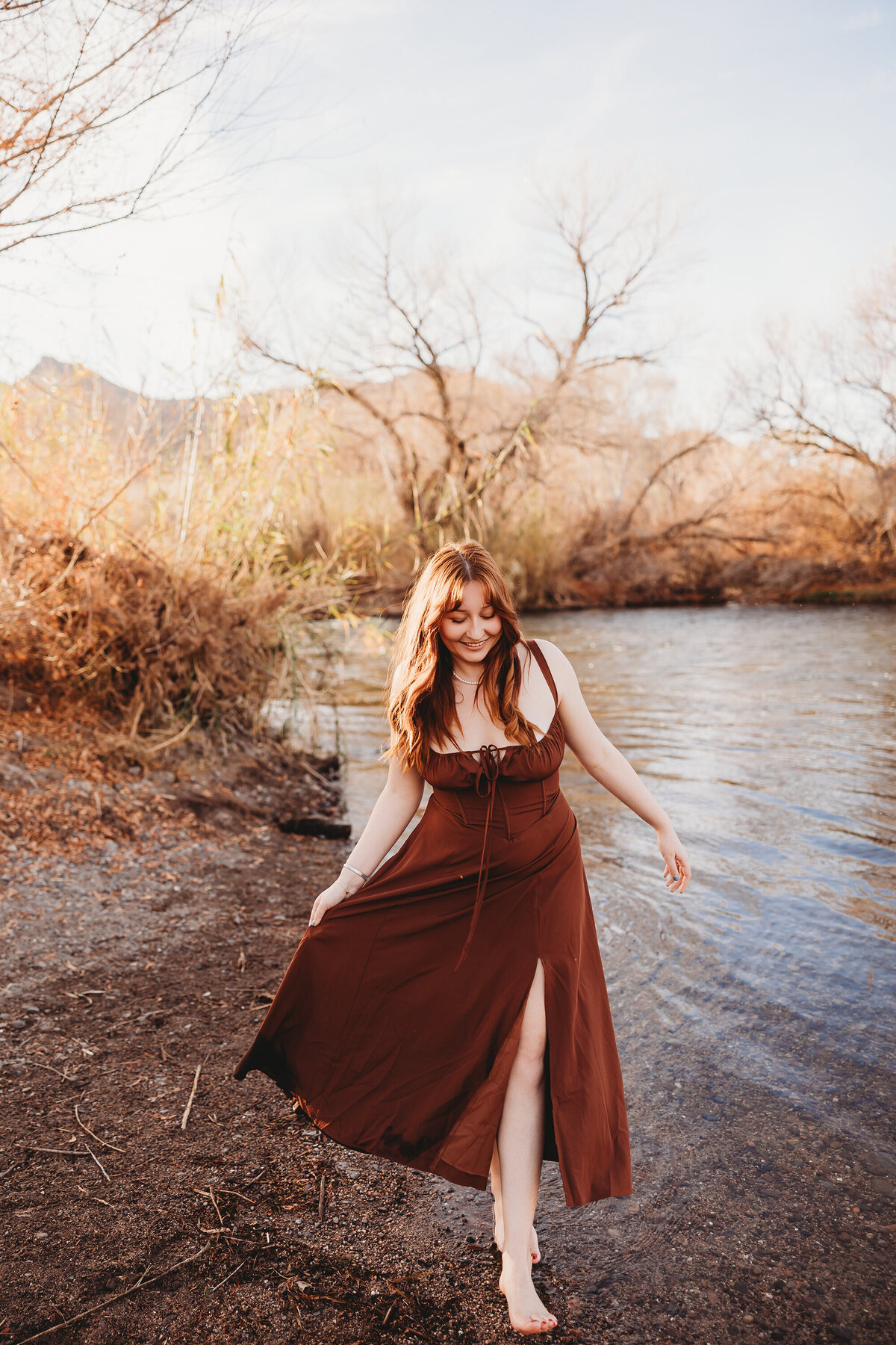 Girl with red hair posing at salt river for senior session by phoenix photographer