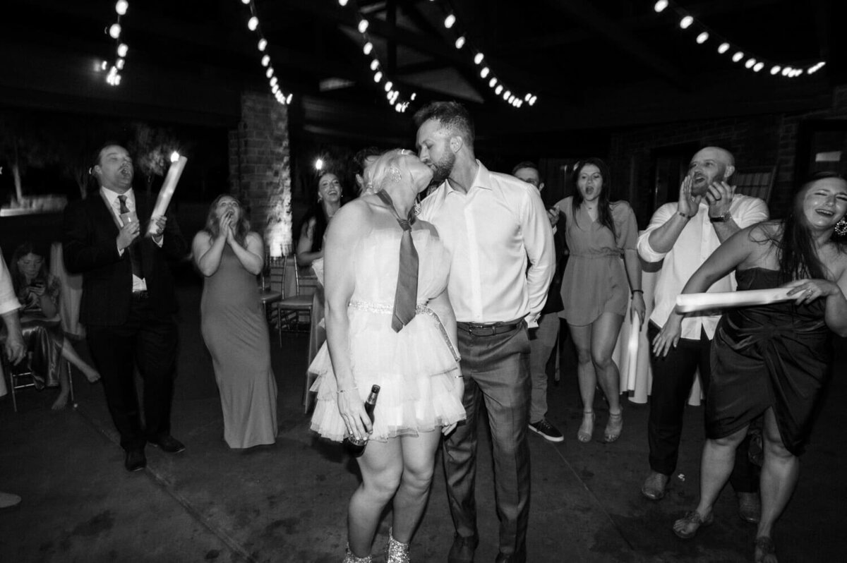 couple-kisses-in-middle-of-packed-dance-floor