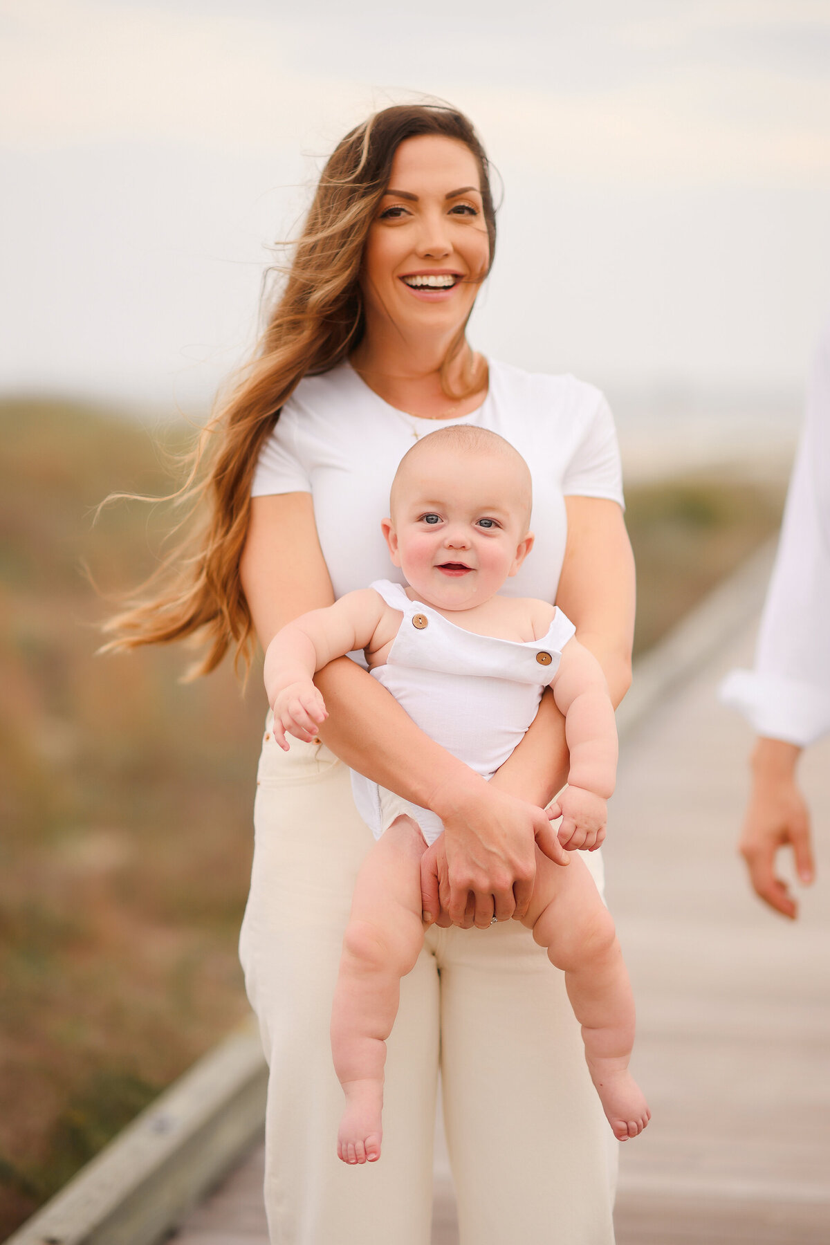 Mother embraces her infant during Family Photos on Isle of Palms. 