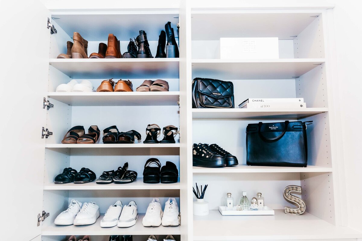 A closet shelf featuring organized shoes and handbags