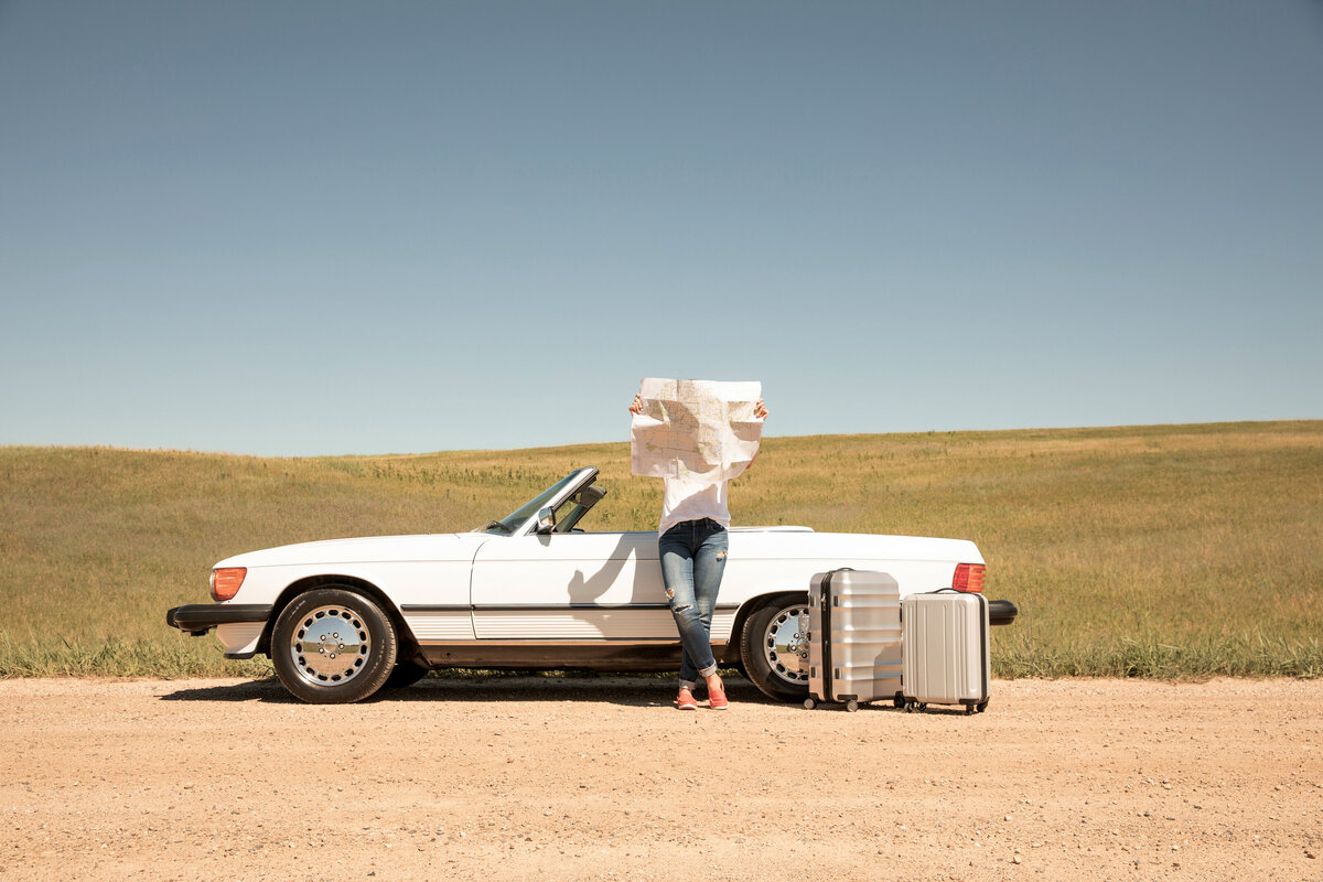 woman-reading-map-on-dirt-road