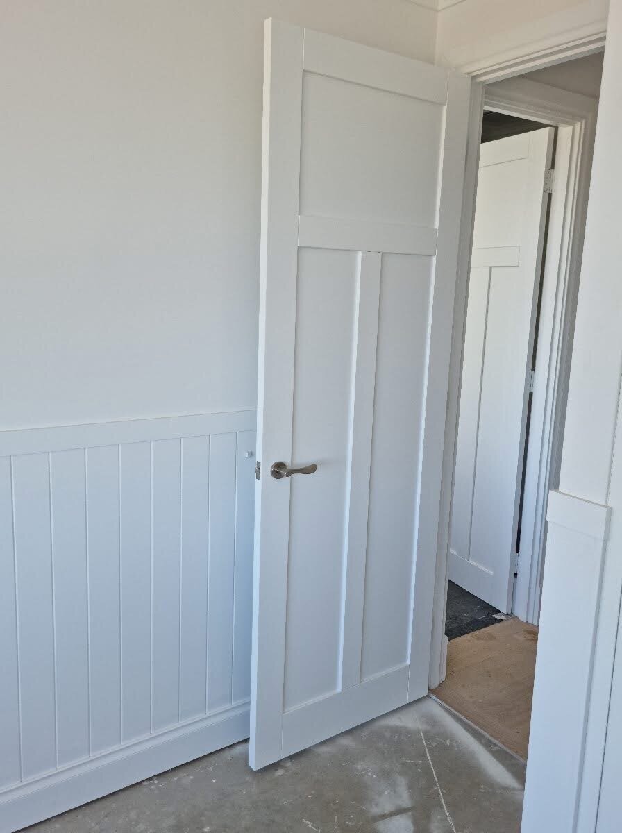 Elegant Hamptons-style doors and door frames painted in fresh white for a coastal-inspired look by New-Style Painting Service.