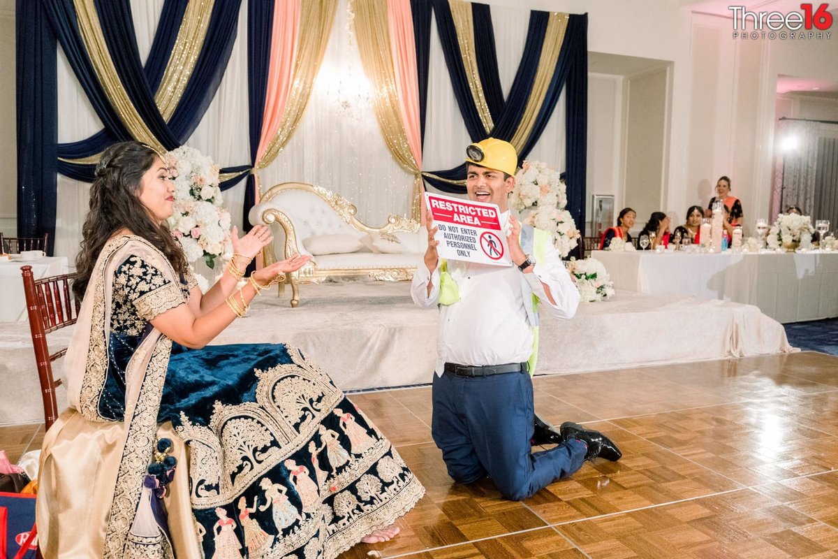 Bride and Groom having fun during the garter belt tradition