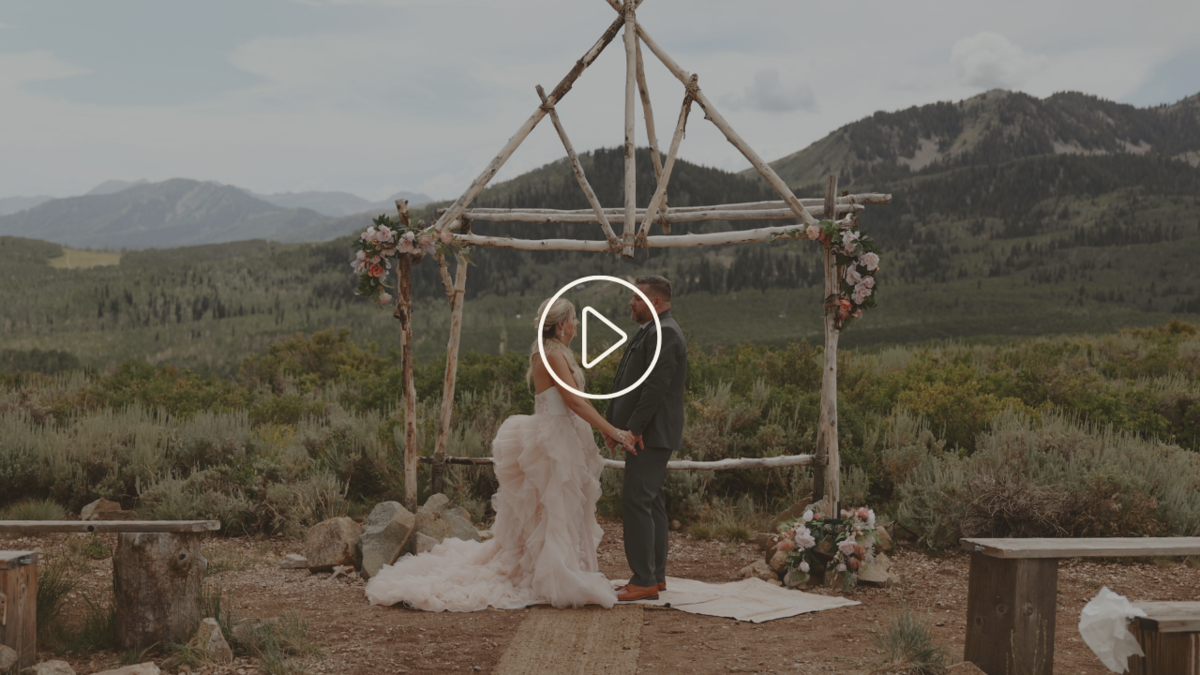 Bride and Groom Holding Hands Under Arch at Elopement in Park City Utah