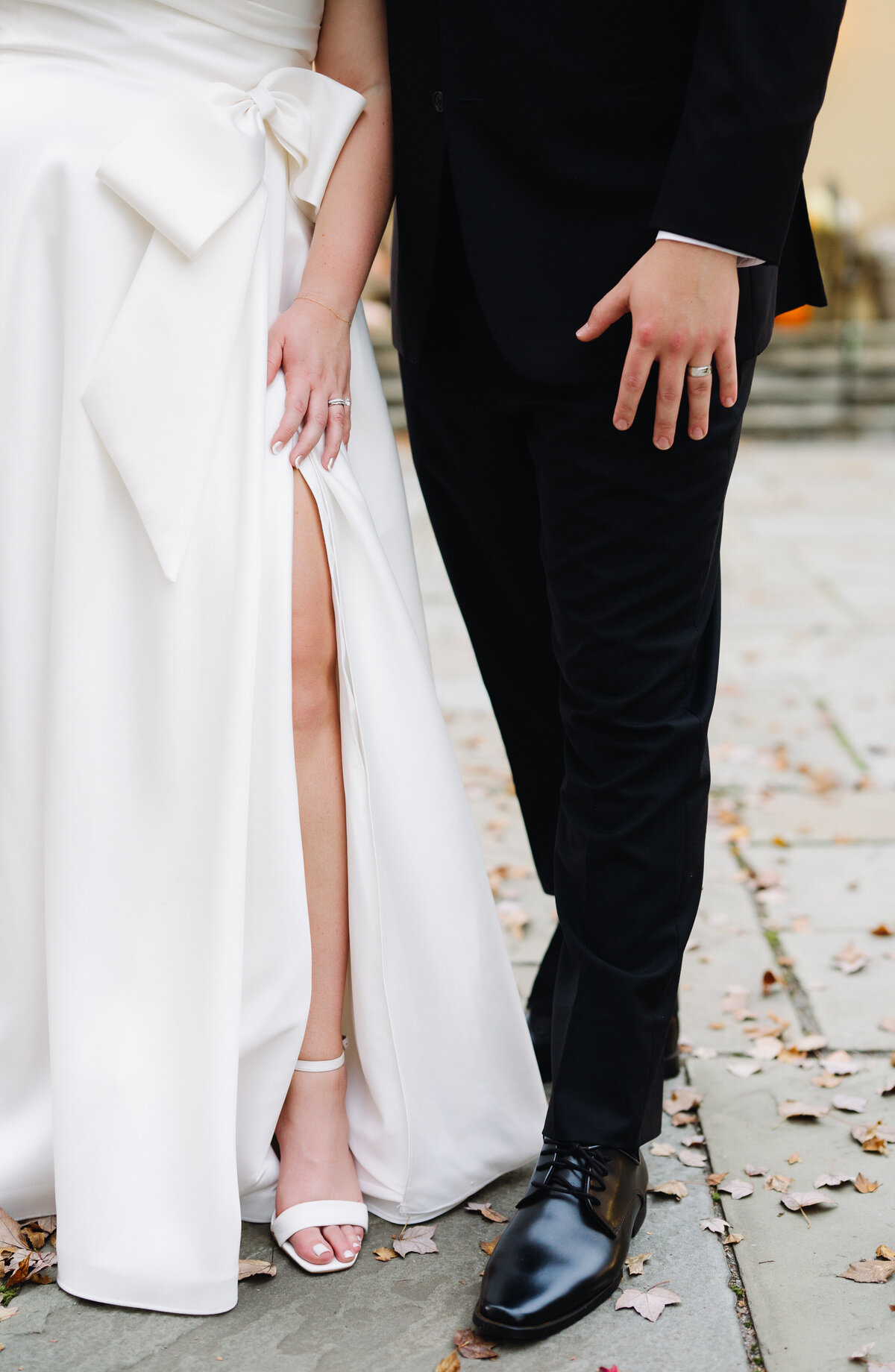 Virginia wedding photographer captures detail shot of bride and groom standing togethr and stowing off their wedding shoes