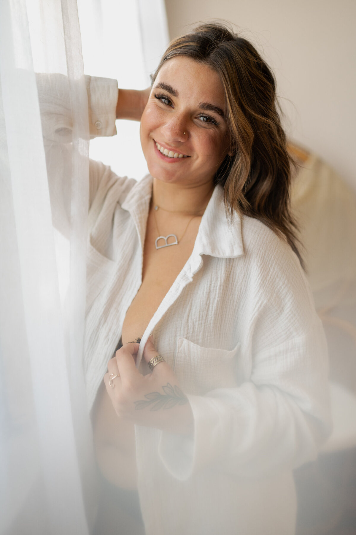 Soft smiles in a white dress shirt during her boudoir photoshoot in Albany, NY.