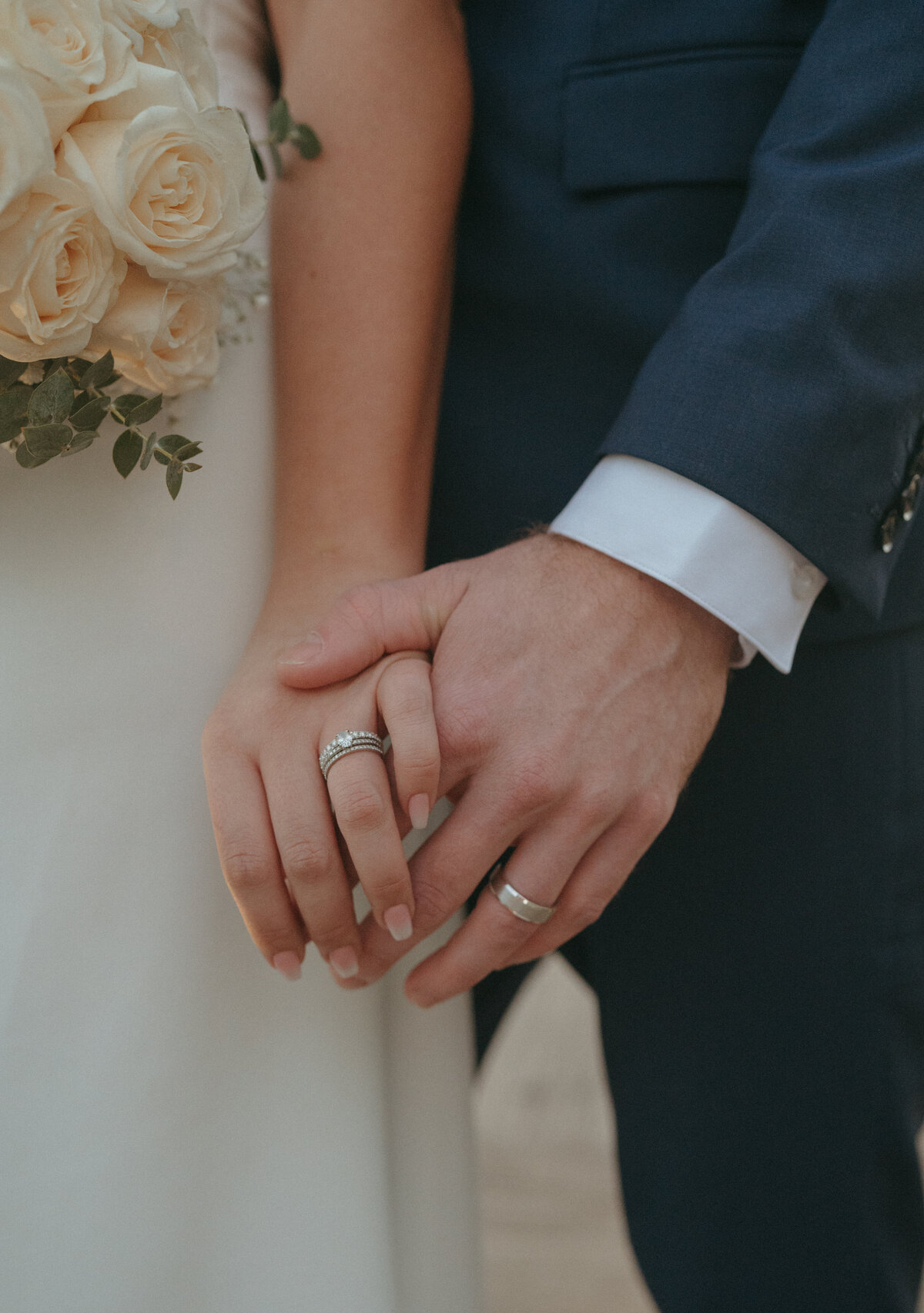 couple holding hands during wedding