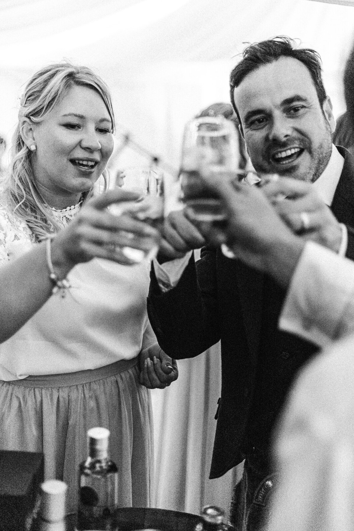 wedding guests cheers during wedding reception photographer catches this candid moment