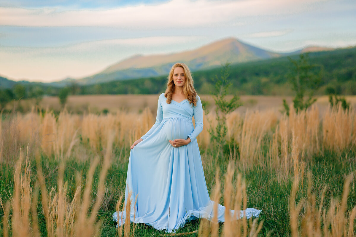 Maternity portrait session wearing blue with view of the mountains