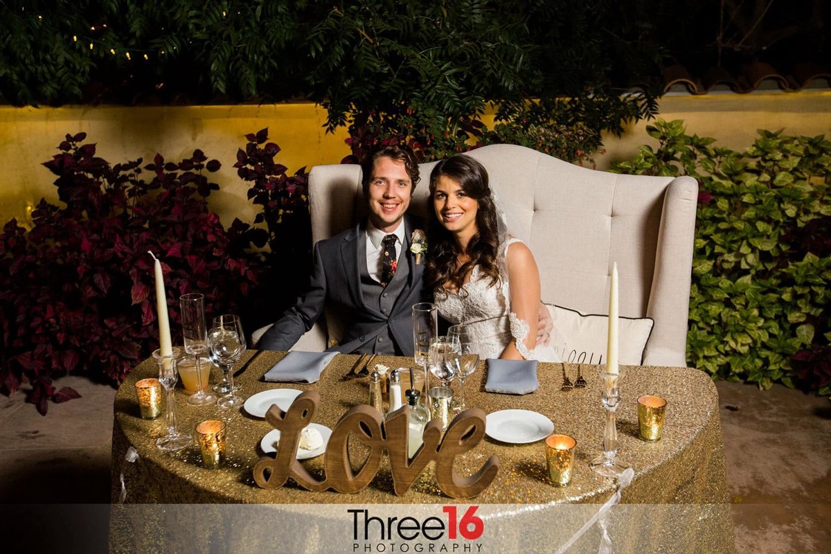 Newly married couple sitting at the Bride and Grooms table