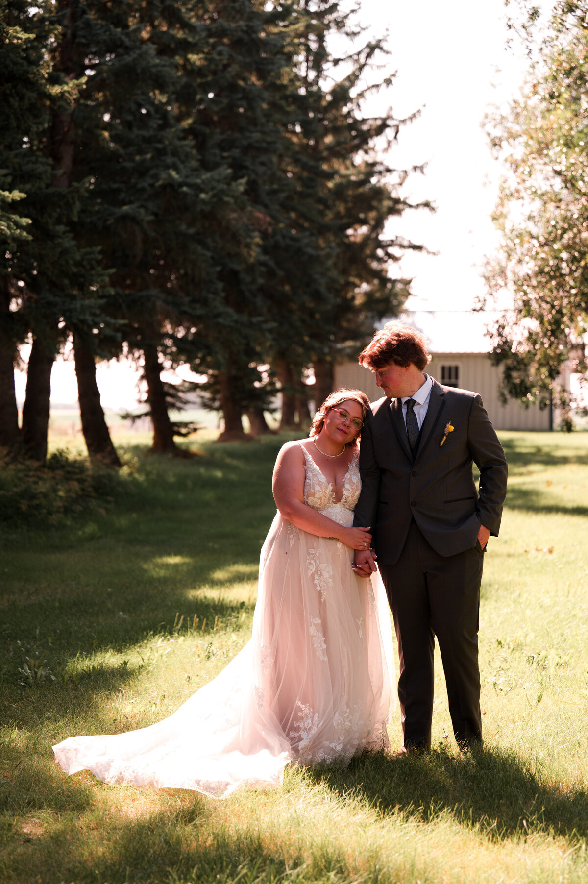 Wedding day portrait taken of the a bride and groom by Ember Dawn Photography at Falkenberg Weddings