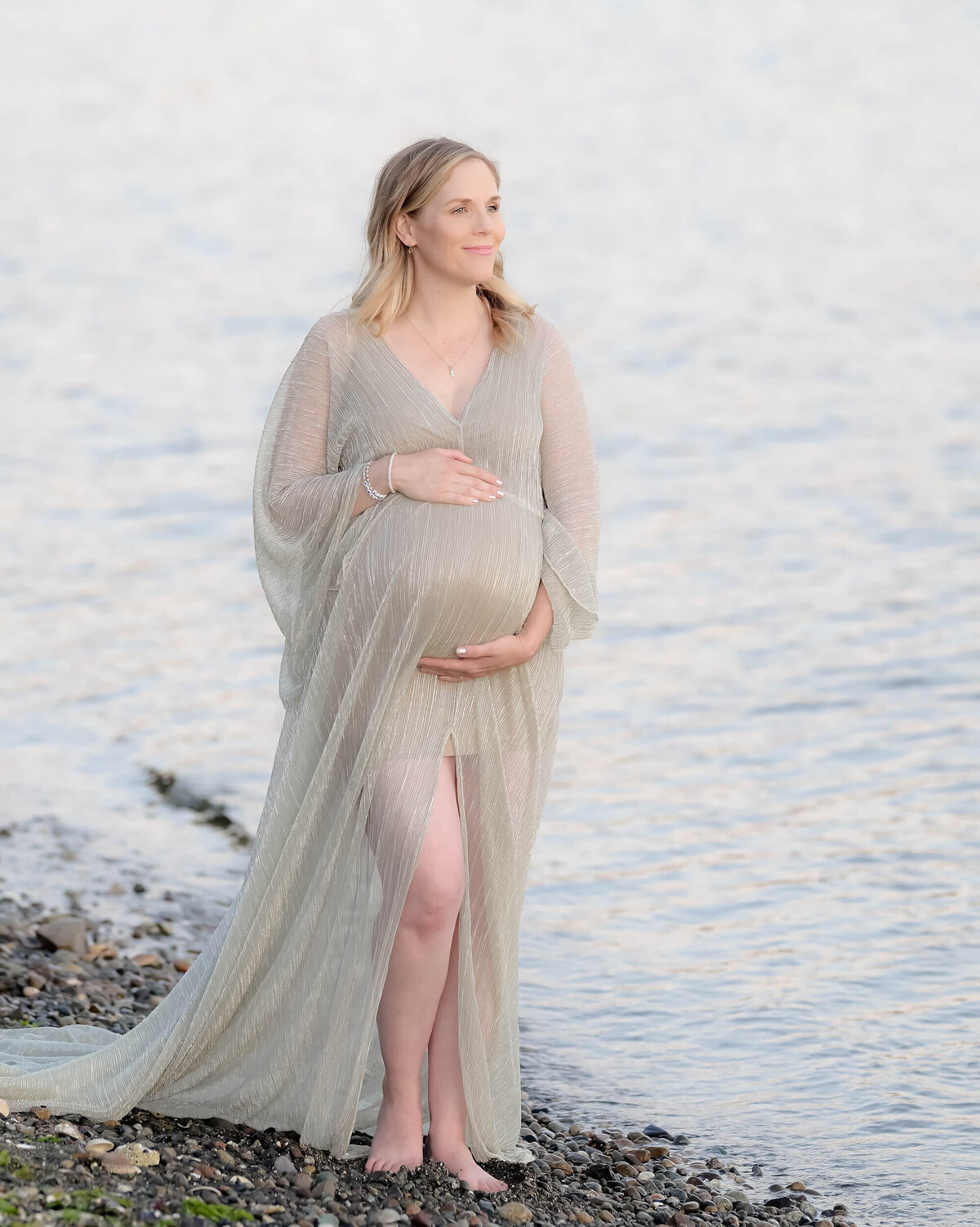 E. Benecki Photography creates this delicate and dreamy maternity photo on a rocky PNW beach. The soft, light tones create an airy, ethereal feel.