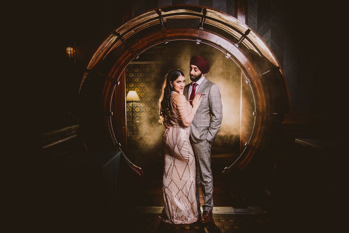 Engaged Bride and groom in formal clothing at a vintage bar in front of a circular doorway at olde bar philadelphia