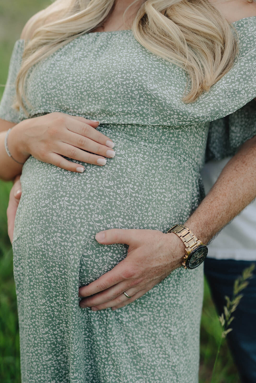 hands covering a baby bump at  maternity session in Finger Lakes, New York