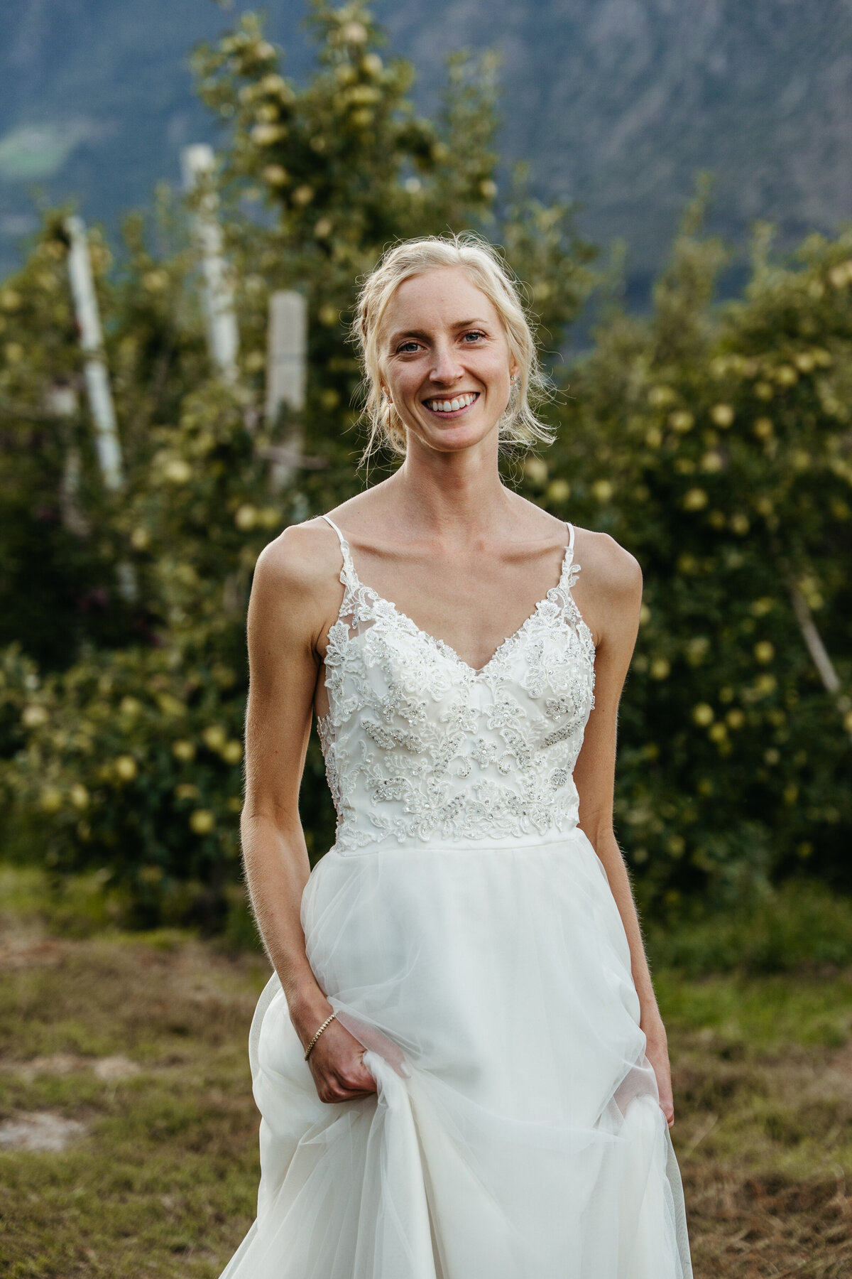 Bride smiling during orchard portraits