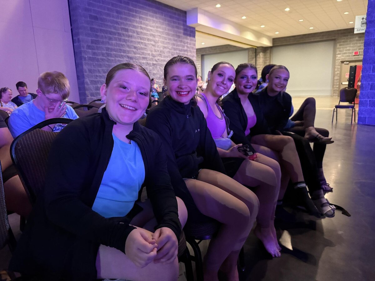 Some of the velocity members cheering on their friends as they watch them at nationals