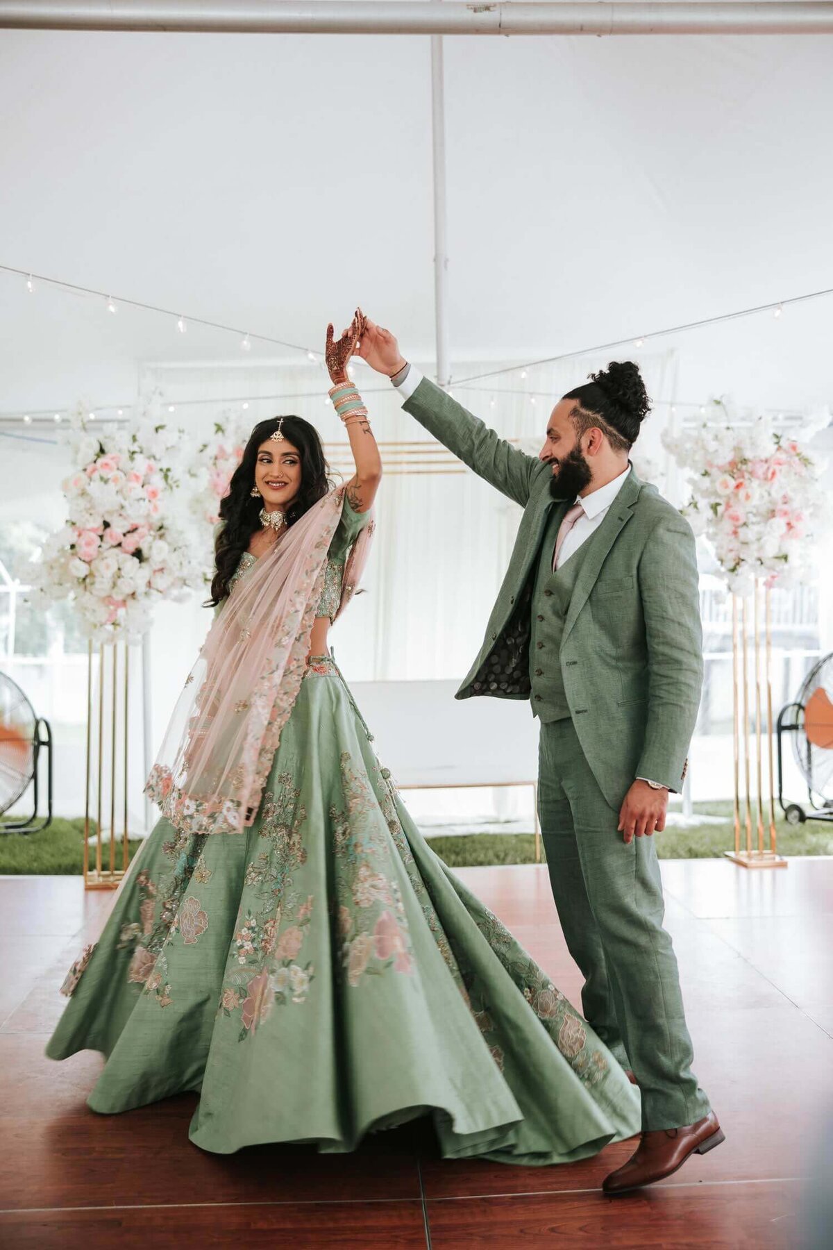 Groom twirls his bride-to-be at a pre-wedding ceremony in the Lehigh Valley. The bride and groom had a backyard wedding.