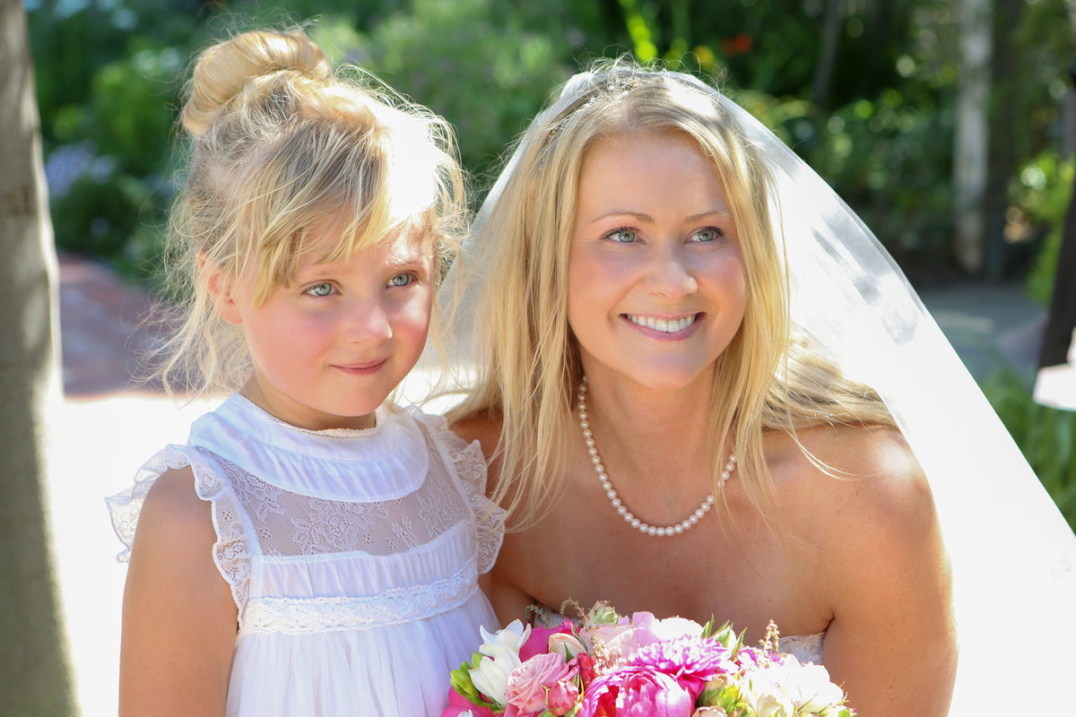 Close-up portrait of bride and flower girl, california outdoor wedding