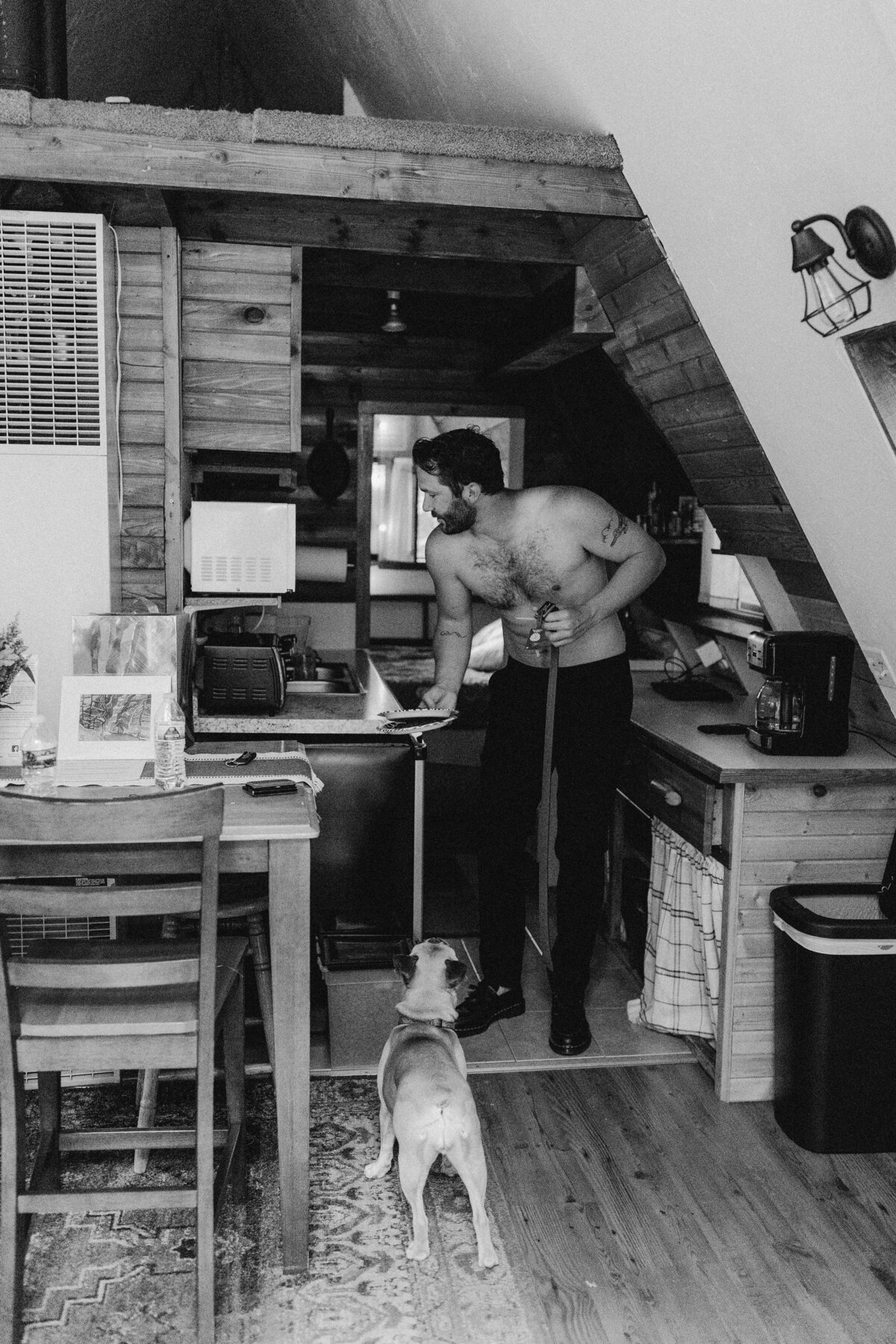 Men in kitchen area with dog in a cabin at Dallenbach Ranch Colorado