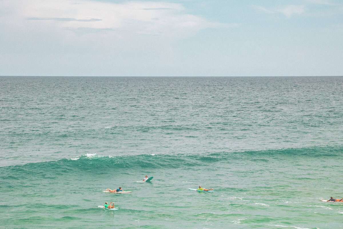 A group of surfers wait for a good wave in the Atlantic Ocean