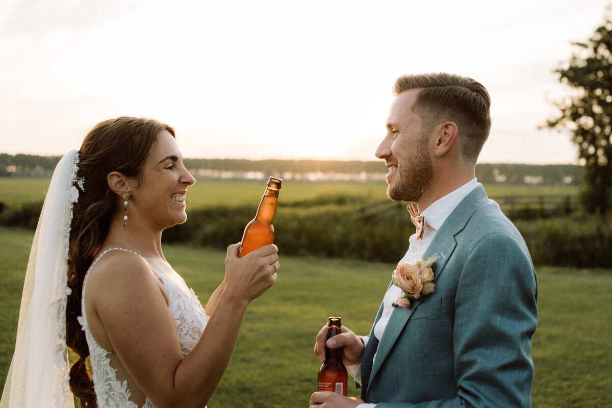 Sfeervolle bruiloft bij Nigtevecht Freeland Farm, met een persoonlijk aangekleed decor en het bruidspaar dat geniet van een lange borrel in een gezellige, intieme sfeer. Proosten met bier. 