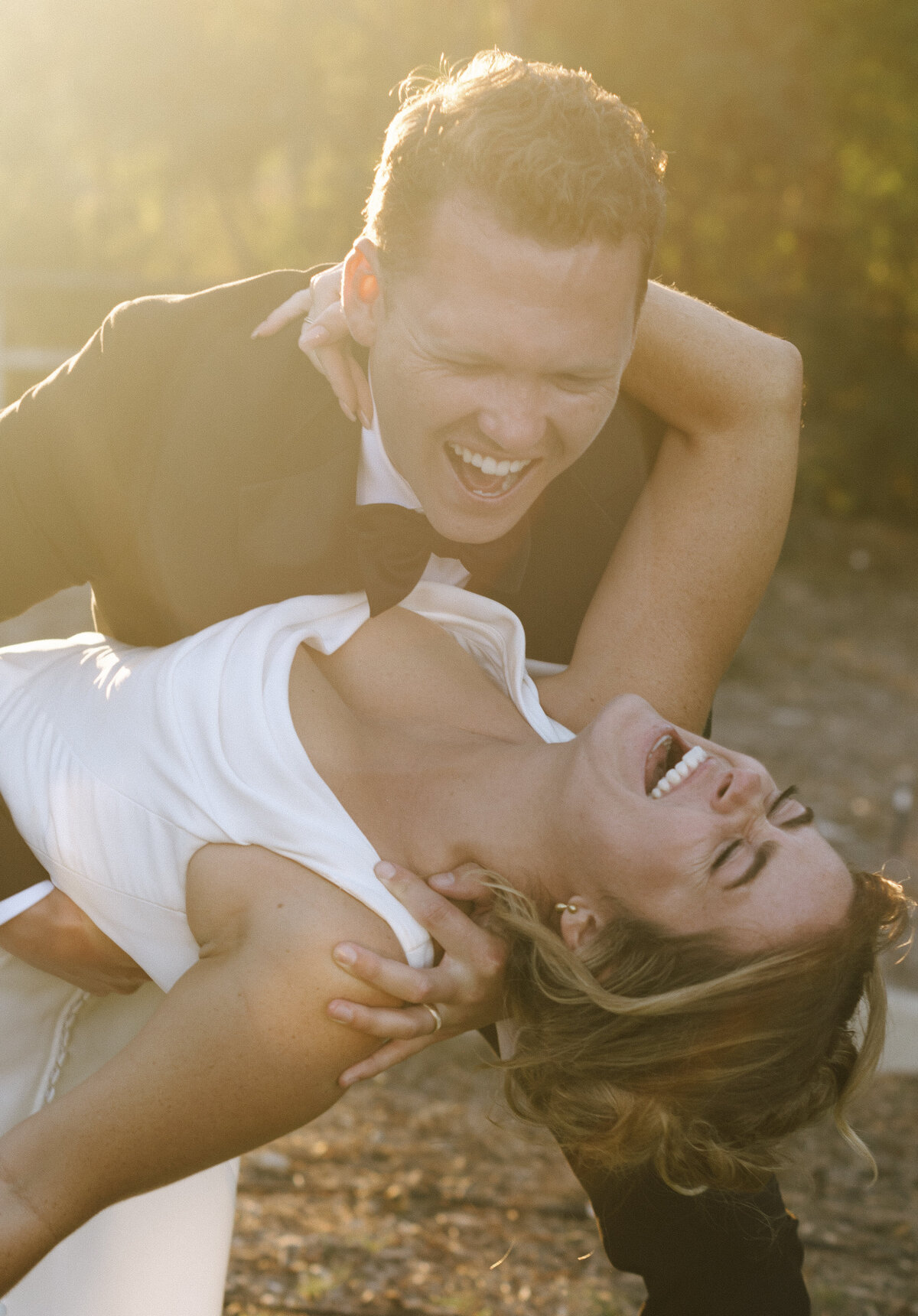 man holding woman and laughing