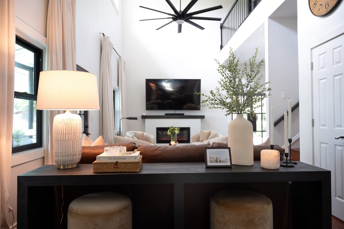 dewine design interiors farmhouse modern living room with black long table with lamp and vase