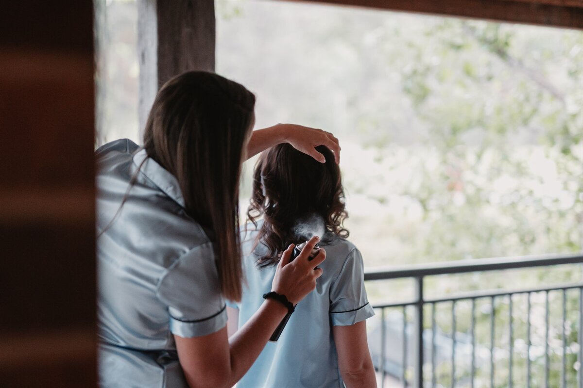 Bridesmaids getting their hair ready for the wedding ceremony