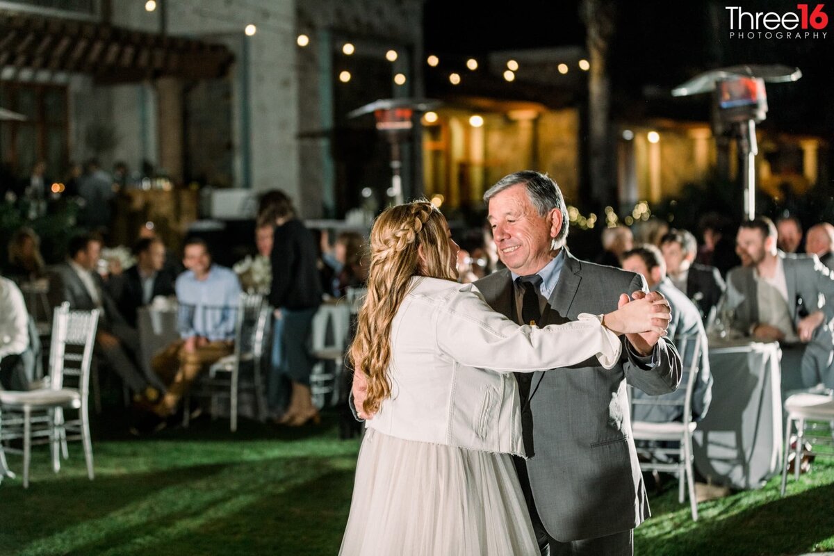 A Bride dances with her dad