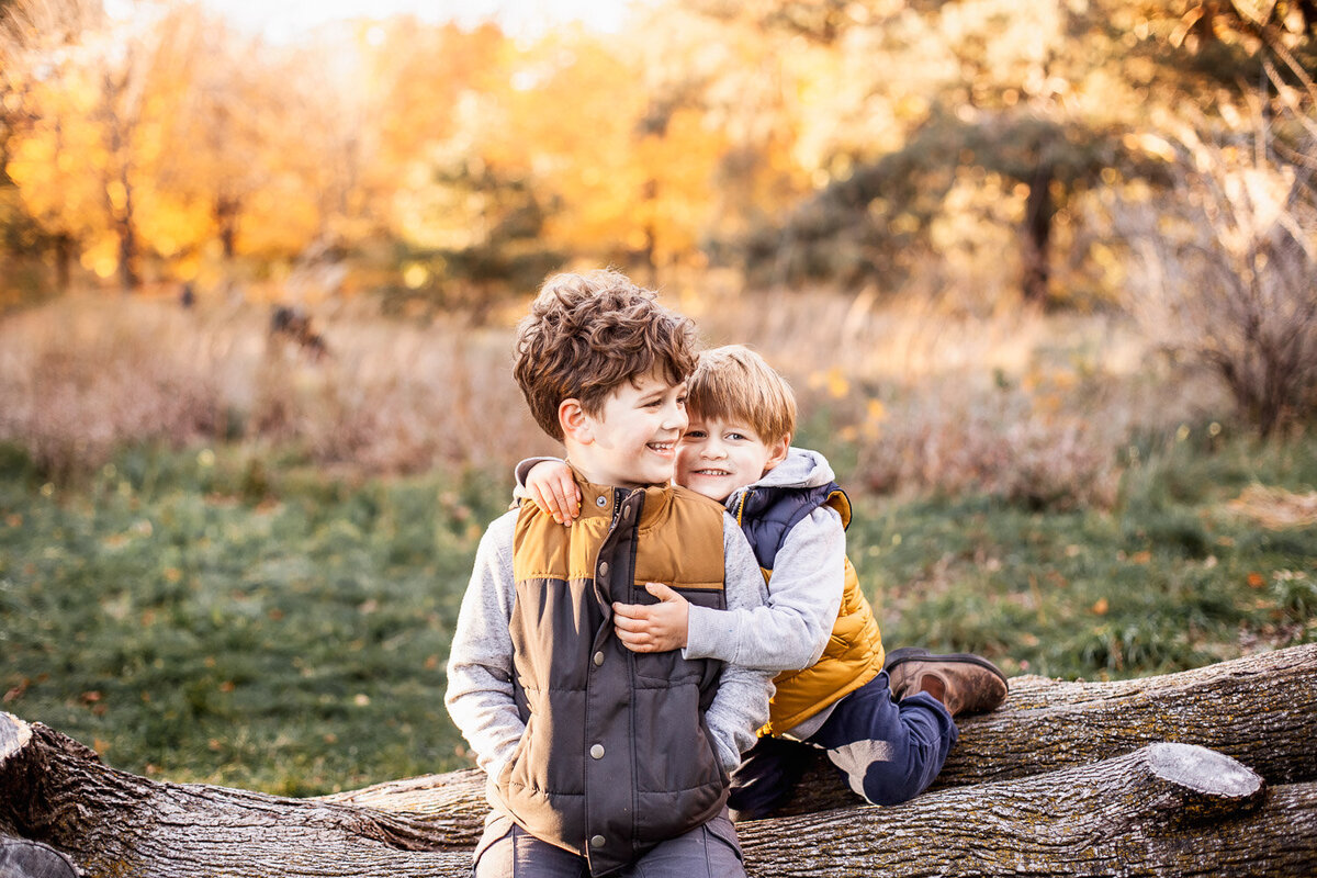 2 young brothers snuggling during fall  family photography session