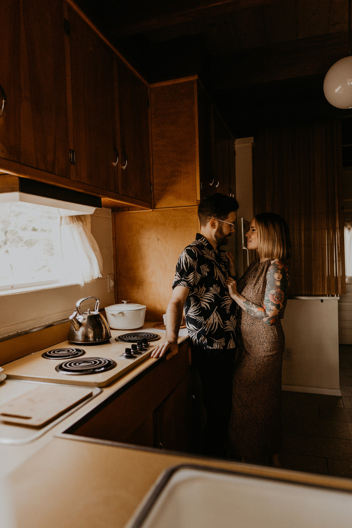 engaged couple hanging out in midcentury modern kitchen