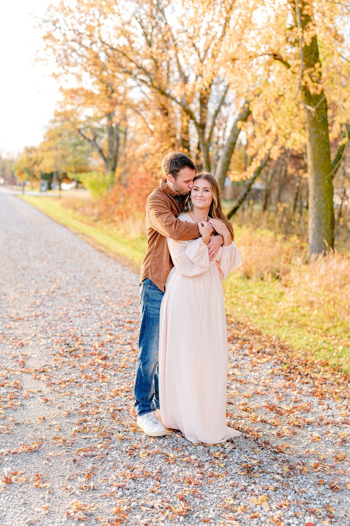 man-kissing-woman-fall-engagement-session