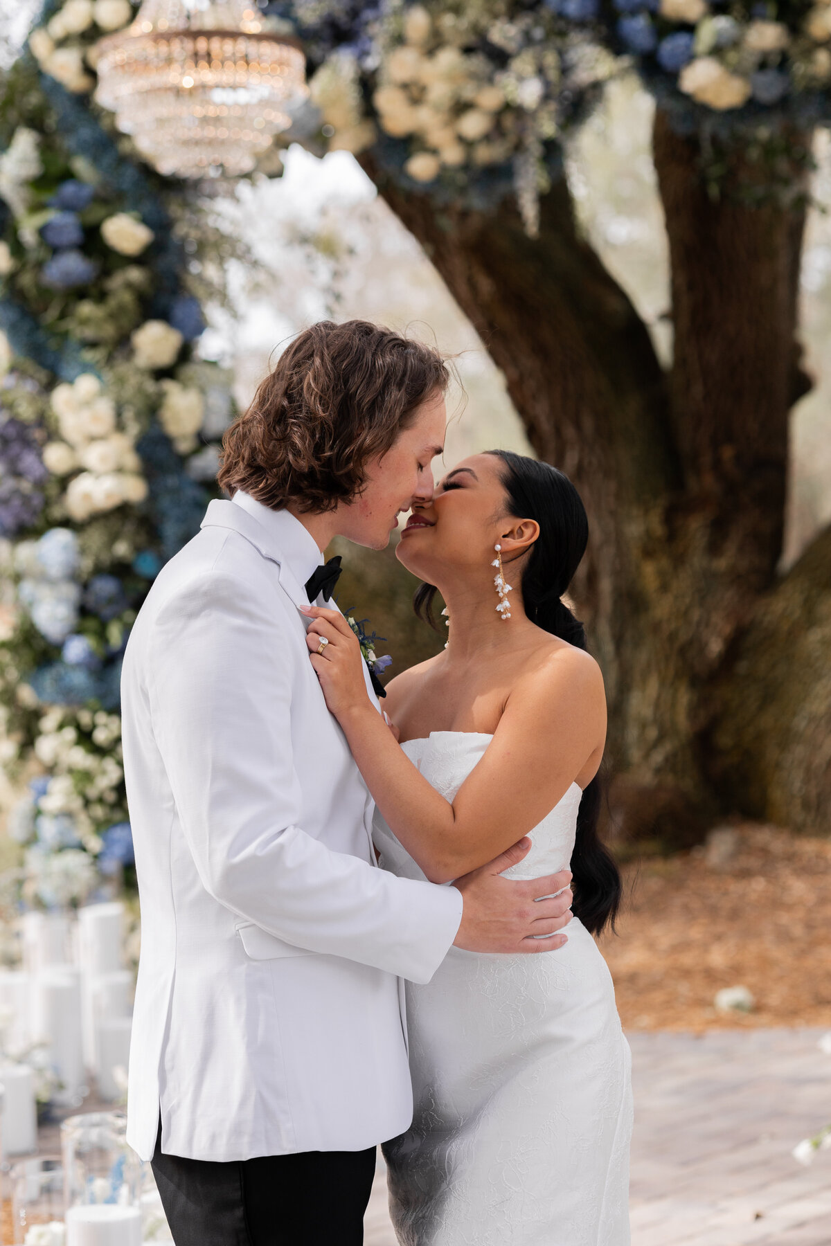 bride and groom smiling at each other at Hewitt Oaks in Savannah Georgia. by destination wedding photographer Amanda Richardson Photography