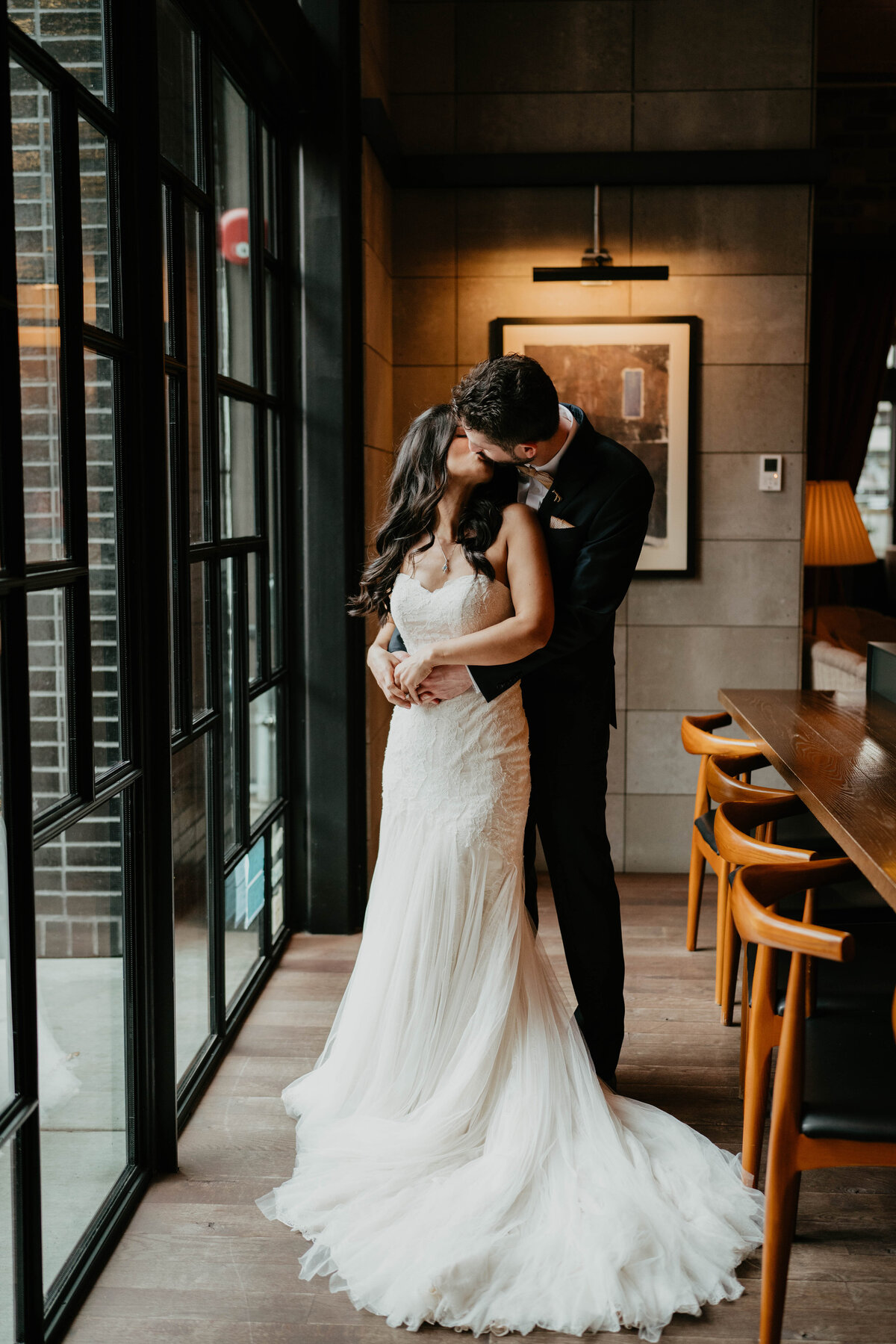 Bride and groom kissing at the Hoxton Hotel in Portland before their wedding